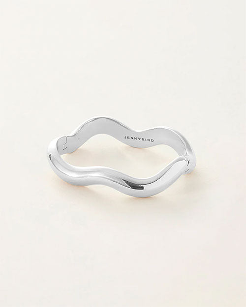 A silver bracelet featuring a sleek, curved design that elegantly wraps around the wrist.