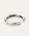A sleek silver tubular bangle, highlighting its refined and modern design.