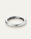A sleek silver tubular bangle, highlighting its refined and modern design.