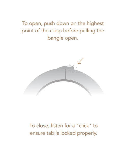 A bracelet displaying instructions to push down on the highest point of the clasp to open it.