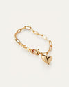 A gold heart bracelet featuring a delicate chain link design, elegantly showcasing its shimmering finish.