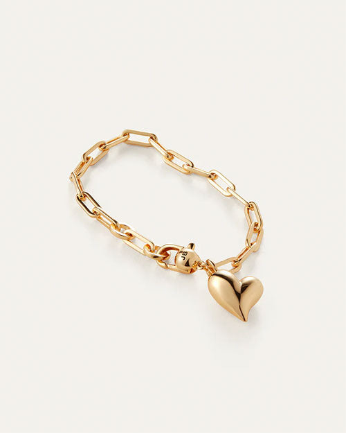 A gold heart bracelet featuring a delicate chain link design, elegantly showcasing its shimmering finish.