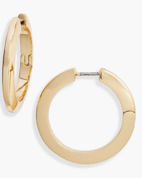 Close-up of shiny gold hoop earrings, showcasing their circular design and polished finish.