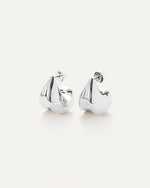 A pair of silver earrings, that make a bold statement by complementing not competing with your outfit.