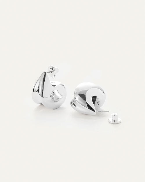 A pair of silver earrings, that make a bold statement by complementing not competing with your outfit.