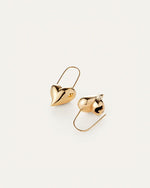 A stylish pair of gold earrings in the shape of hearts, highlighting their romantic and timeless appeal.