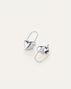 A pair of silver earrings shaped like hearts
