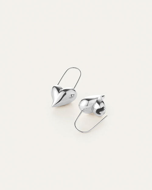 A pair of silver earrings shaped like hearts