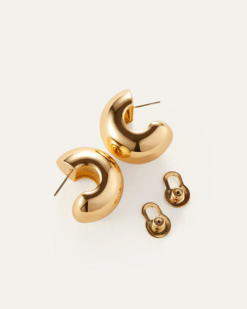 Gold plated earrings displayed alongside a matching pair, showcasing their elegant design and shiny finish.