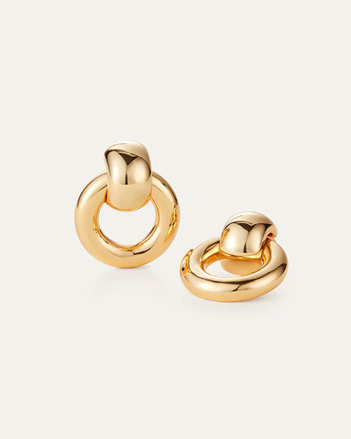 A pair of gold-tone earrings with a distinctive circle design, highlighting their modern and elegant aesthetic.