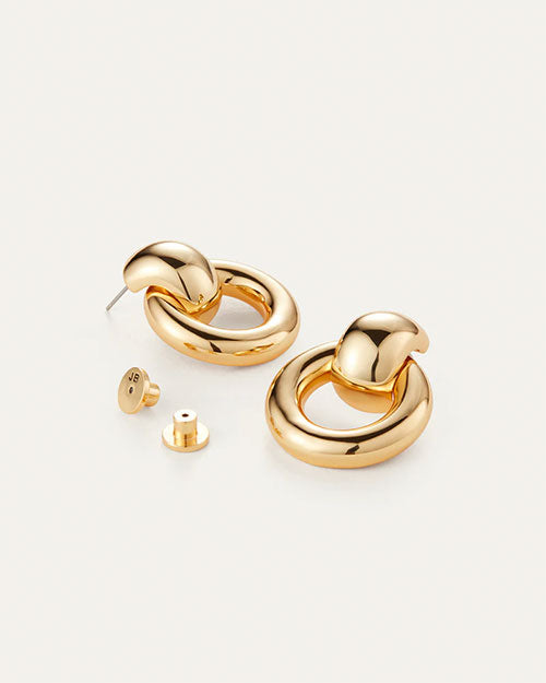 Elegant gold tone earrings with a distinctive circular design, perfect for enhancing any outfit.