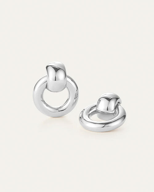 Two silver earrings featuring a circular design, elegantly crafted for a modern and stylish look.