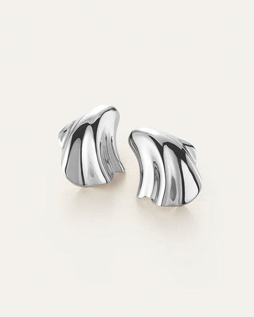 A pair of silver earrings with an abstract, fluid design which 
resembles a seashell.