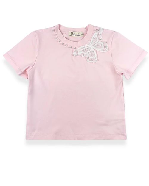  A little girl's pink t-shirt featuring a white lace trim and a butterfly motif with pearl studs.