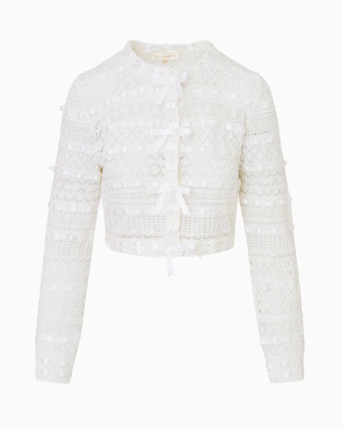 A white cropped cardigan featuring delicate lace detailing along the edges.