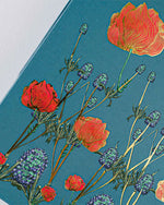Floral pattern in blue and red against a solid blue background.