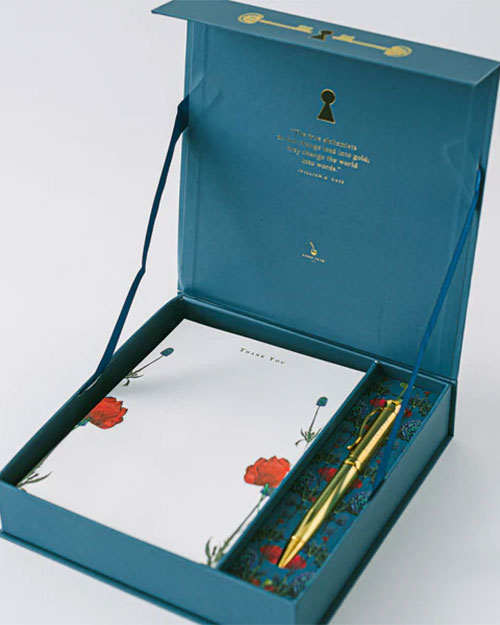 A blue box holds a pen and notepad, showcasing Good Juju Ink Enchanted Garden Lux Thank You Stationery design.