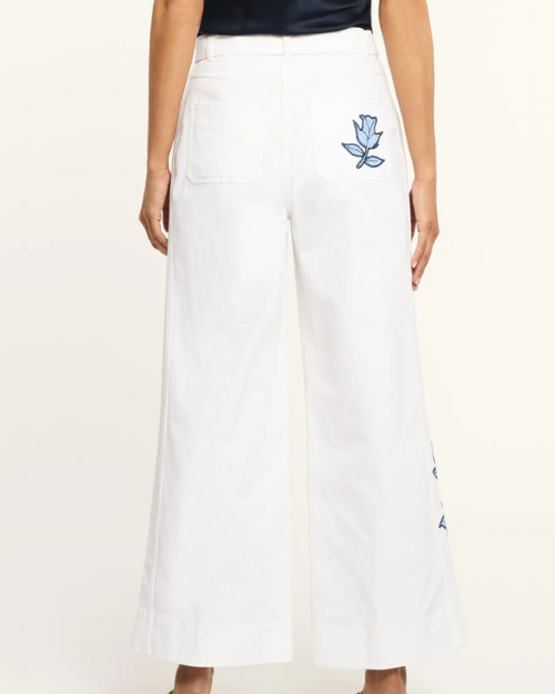 White pants with a blue floral design on a white background