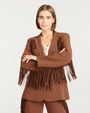 Woman wearing a brown fringed suit on a white background