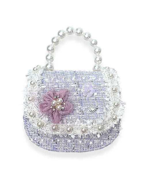 A chic purple purse embellished with pearls and floral accents, representing a unique and trendy accessory choice.