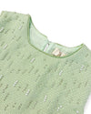 Up-close detail of a green tweed vest, embellished with beading and pearls on the front.