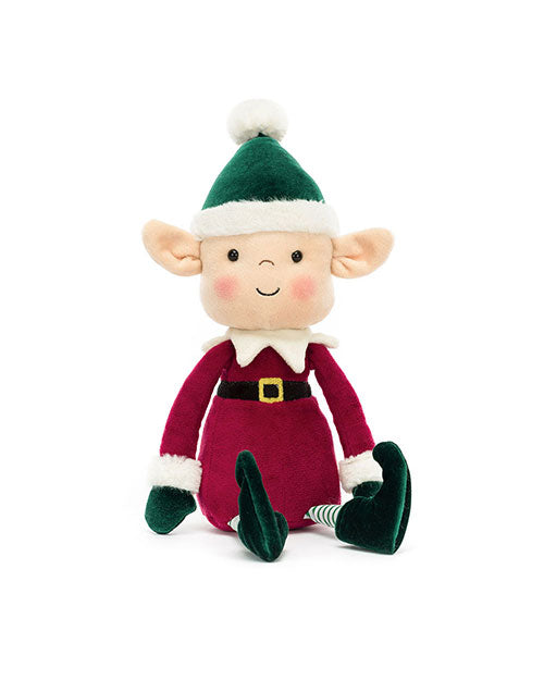Plush elf toy wearing a green hat with a white pom-pom, red outfit with white cuffs and collar, black belt with yellow buckle, green shoes, and striped socks, featuring large ears, rosy cheeks, and a smiling face.