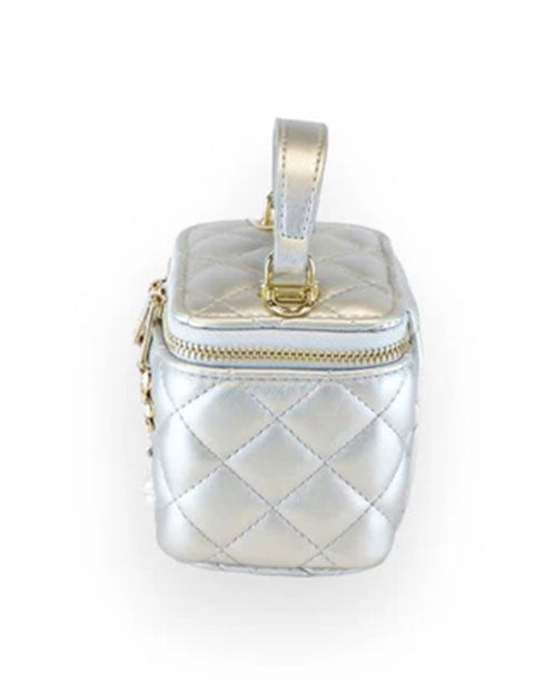 Side view of a small metallic silver quilted vanity-style handbag with a top handle, gold-tone hardware, and a plain diamond-stitched design without embellishments.