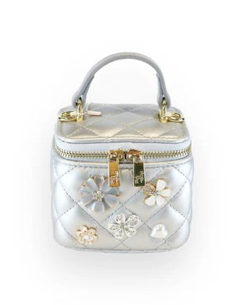 Small metallic silver quilted vanity-style handbag with a top handle, gold-tone hardware, and decorative floral embellishments in silver, white, and crystal accents on the front.