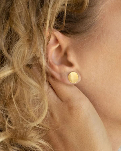 Model wearing Hammered Concave Gold Disc Earring.