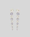 Quin earrings on a grey background.