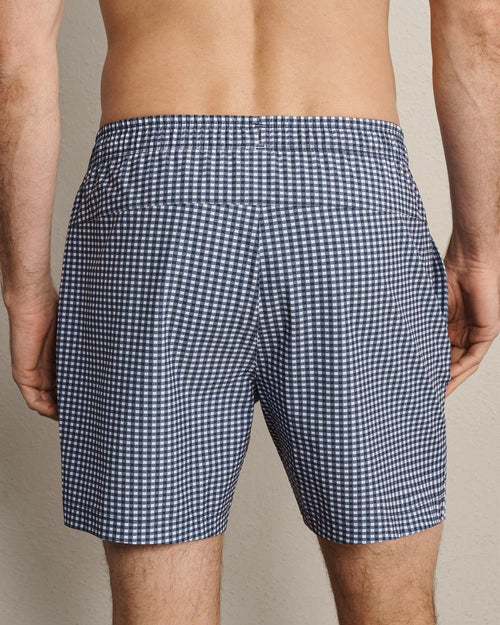 Back view of navy and white gingham swim trunks featuring a classic check pattern, lightweight quick-dry fabric, and relaxed fit.