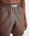 Up-close image of the Men's swim shorts that are blue and have orange nautical knots and ropes going vertically down in rows across the swim shorts.  The swim shorts have a fully elasticated waistband and white drawstring tie.