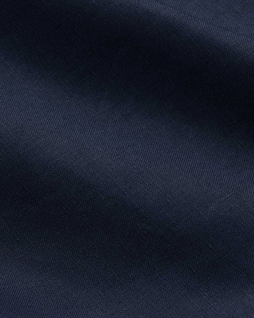 Close-up of dark blue fabric, showcasing the texture of navy pants.