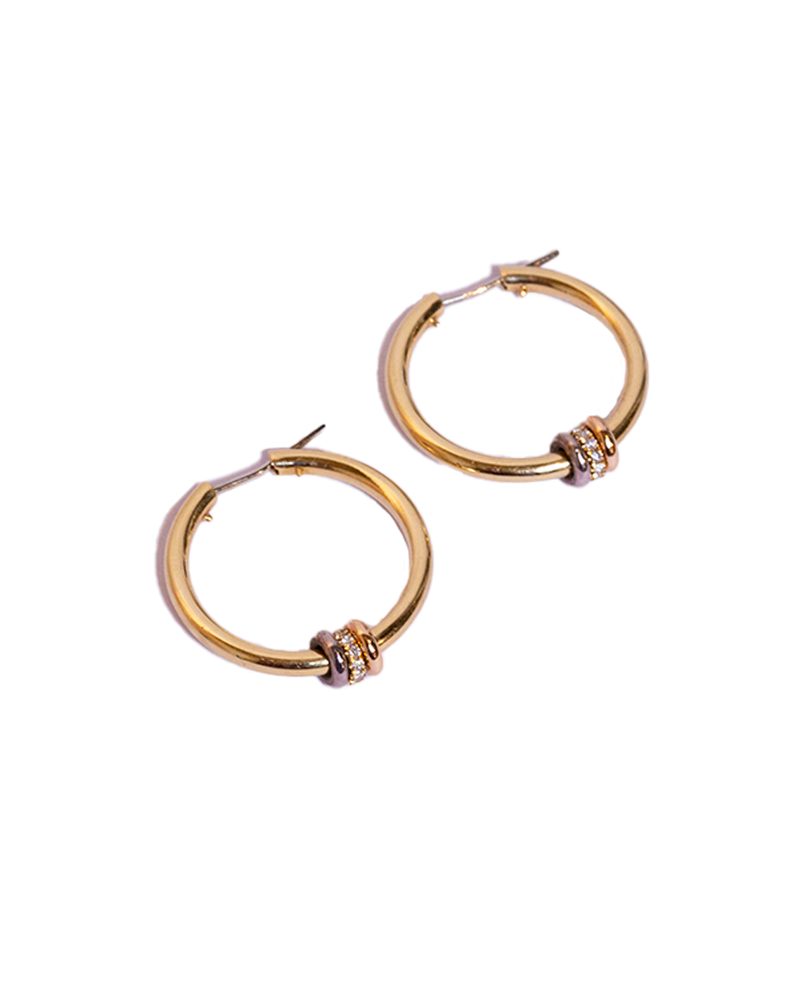 Gold hoop earrings with rose gold, diamond, and silver annulets on hoop.