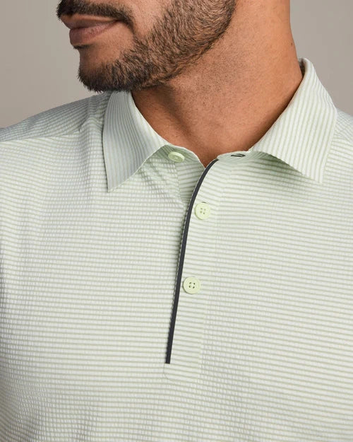 Close-up of a light green striped performance polo shirt featuring a classic collar, two-button placket, and subtle horizontal stripe pattern.