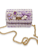 Purple tweed and gold chain little girls purse with a quilted purple and gold bear charm, purple jewel with little pearls around charm, gold twist clasp, and a small purple bow with a pearl dangling off the middle of the bow on the front flap of the purse