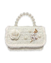 An image of a girl's ivory tweed purse with a large pearl handle, the front flap has white fur around the edge and a tweed ivory flower on the front, with 3 large pearls spaced out around an ivory and gold deer charm.  