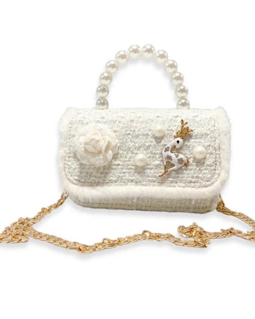 A girl's ivory tweed purse with a large pearl handle and a detachable gold chain, the front flap has white fur around the edge and a tweed ivory flower on the front, with 3 large pearls spaced out around an ivory and gold deer charm.  