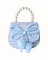 Little girls blue tweed pearl handle purse with a large blue thin string bow on the front with a pearl in the middle of the bow.