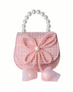 Little girls pink tweed pearl handle purse with a large pink thin string bow on the front with a pearl in the middle of the bow.