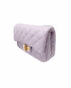 Side view of a stylish purple purses with gold accents, including a quilted texture, golden clasp, pearl charm, and detachable chain.