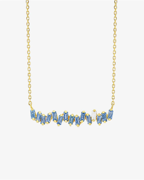 Gold chain necklace with light blue baguette cut sapphires and white diamond. 