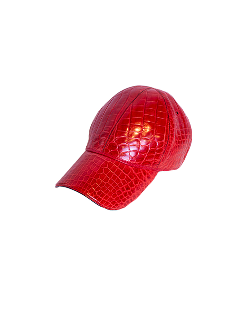 Red crocodile baseball cap in front of white background.