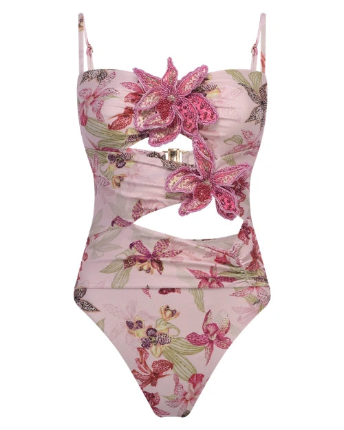 Pink floral print bodysuit featuring 3D flower appliqués, adjustable spaghetti straps, and stylish front and waist cutout details on a white background.