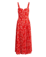 A red floral pleated midi dress with thin straps on a plain background.
