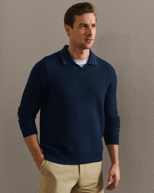 Person wearing a navy blue textured knit long-sleeve polo shirt paired with khaki trousers in a smart casual outfit.