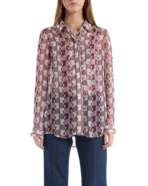 A woman wearing a burgundy and white patterned shirt, showcasing a stylish and contemporary design.