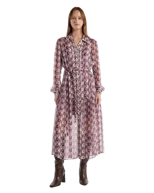 A woman in a long-sleeved dress featuring a unique patterned fabric, highlighting its stylish and contemporary design.