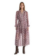 A woman in a long-sleeved dress featuring a unique patterned fabric, highlighting its stylish and contemporary design.