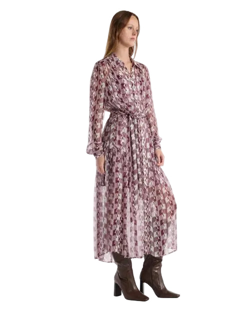 A woman is wearing a long dress featuring a vibrant, patterned print, highlighting its elegant design and style.